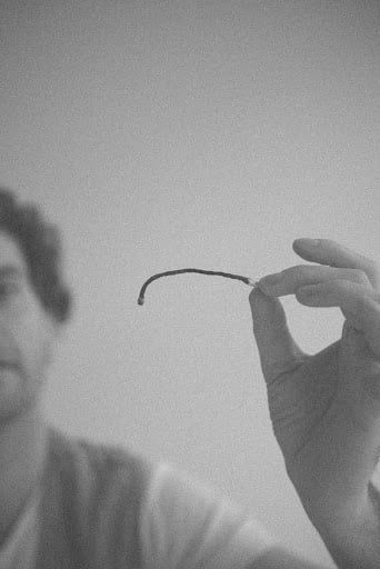 A man holds a burned matchstick in front of his face, creating a menacing interpretation of a malignant narcissist.