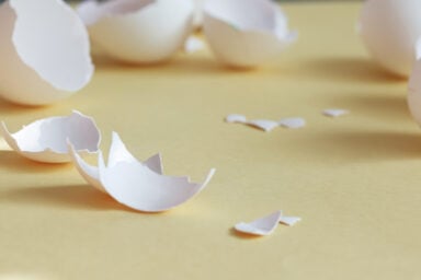 Broken eggshells scattered on the floor, illustrating the unhealthy dynamic of walking on eggshells in a relationship